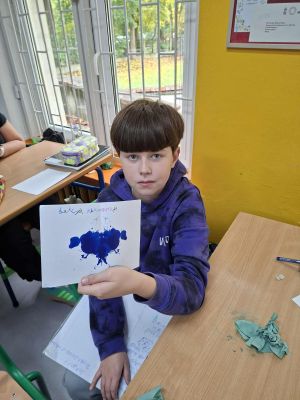 Uczniowie prezentujący swoją kleksografię